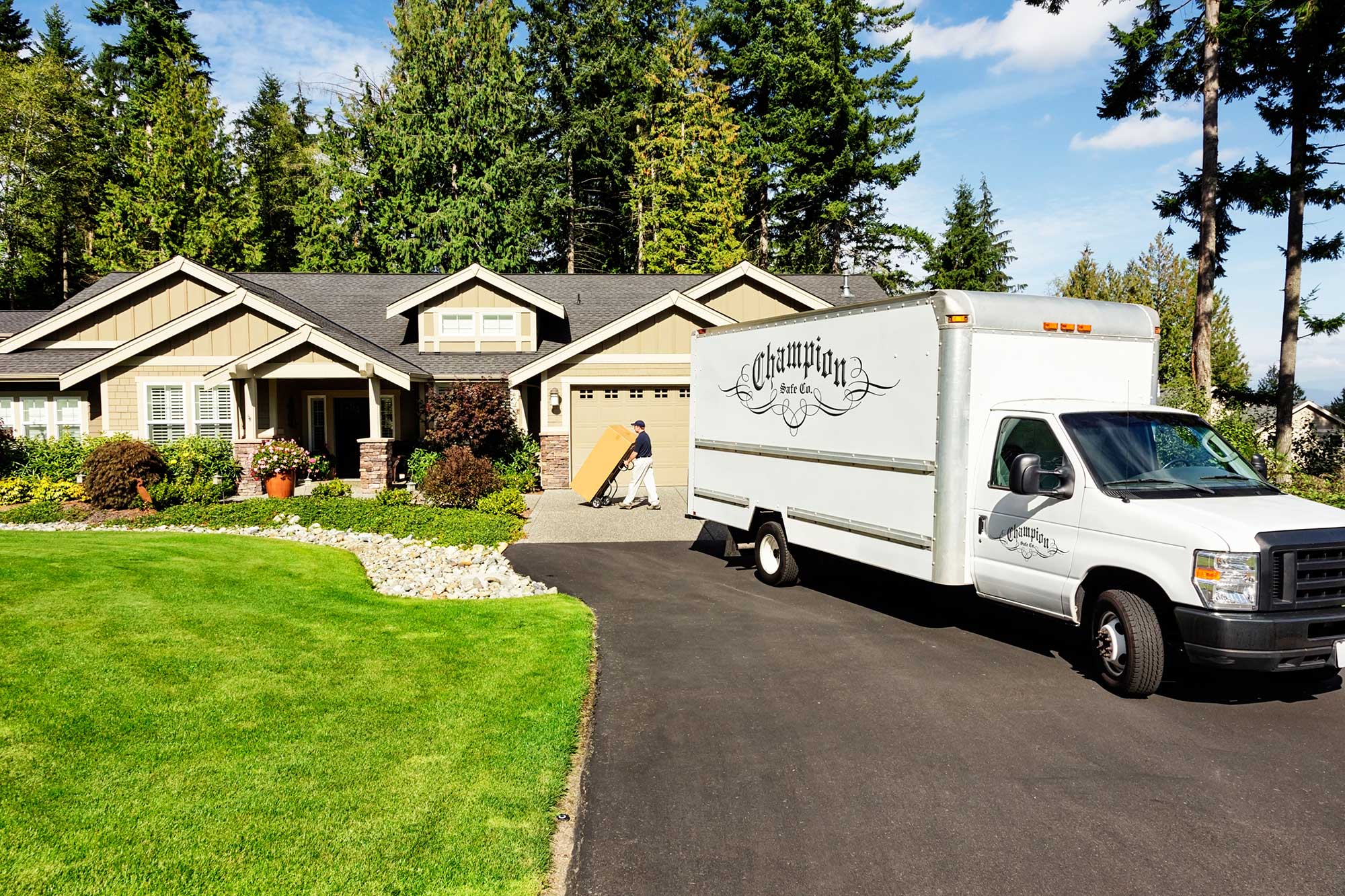 Champion Safe Co delivery truck in front of house
