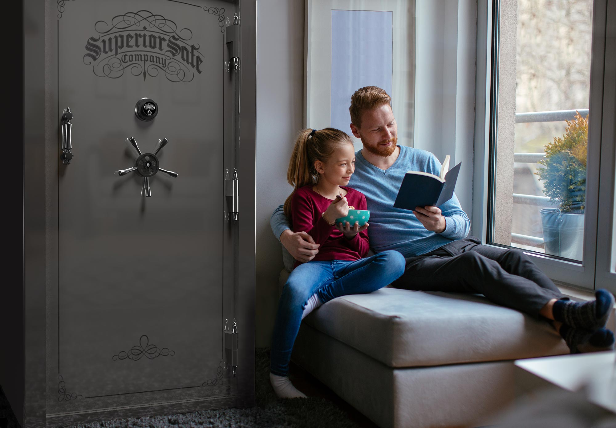 Father and daughter reading with gun safe installed in living room